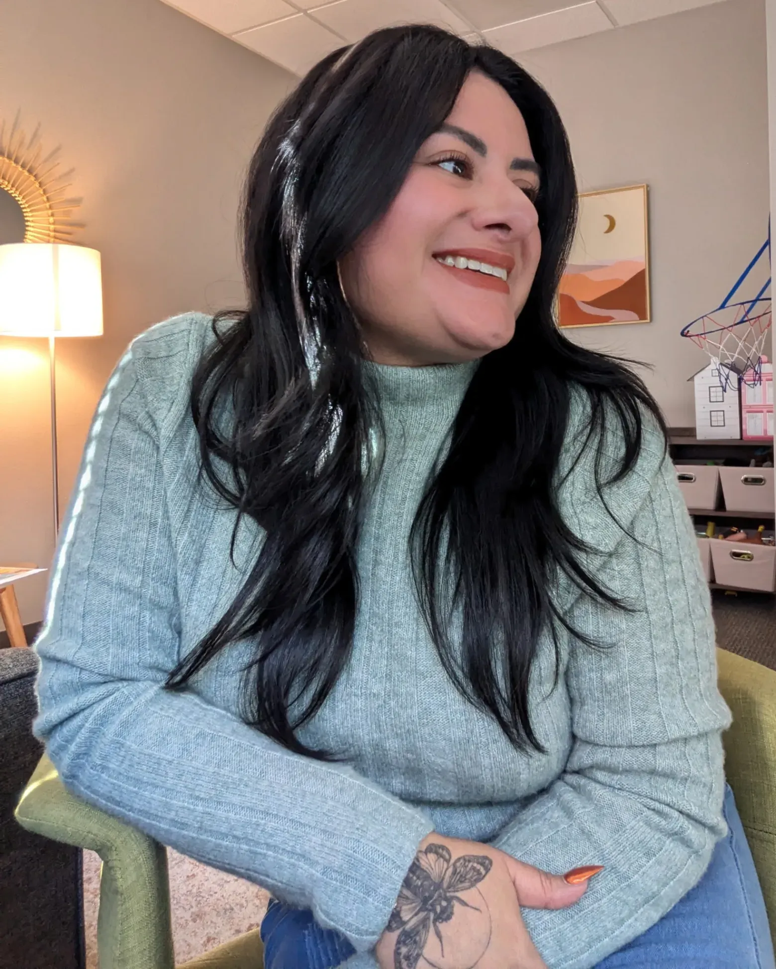 Latina counselor Monica Vajello at work monitoring children inside a Northwest Arkansas play therapy clinic late last year. Credit: Photo courtesy of Monica Vallejo